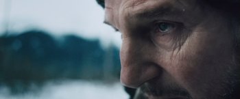 Movie still from “The Grey” (2011), directed by Joe Carnahan – A man's face with blue eyes; Extreme Close Up shot, Over the shoulder angle