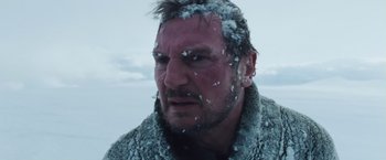 Movie still from “The Grey” (2011), directed by Joe Carnahan – A person with snow on his head; Close Up shot, Low angle