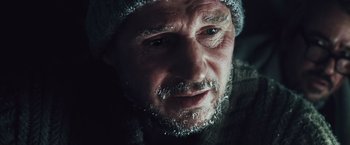 Movie still from “The Grey” (2011), directed by Joe Carnahan – A person wearing a hat; Close Up shot, Low angle