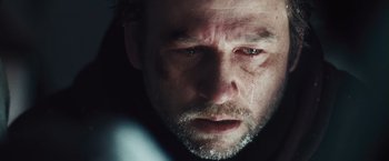 Movie still from “The Grey” (2011), directed by Joe Carnahan – A man's face with tears in his eyes; Extreme Close Up shot, Over the shoulder angle
