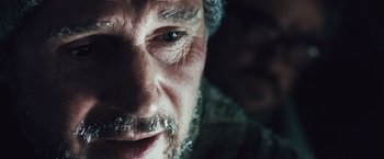 Movie still from “The Grey” (2011), directed by Joe Carnahan – A man's face with a beard; Extreme Close Up shot, Over the shoulder angle