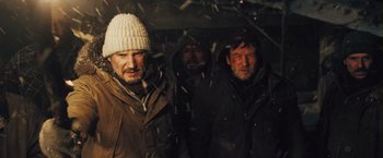 Movie still from “The Grey” (2011), directed by Joe Carnahan – A group of men standing next to each other in the snow; Medium shot, Low angle