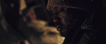 Movie still from “The Grey” (2011), directed by Joe Carnahan – A person wearing a hat; Close Up shot, Low angle