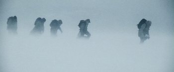 Movie still from “The Grey” (2011), directed by Joe Carnahan – Two people in the snow with backpacks and backpacks on; Wide shot, Low angle