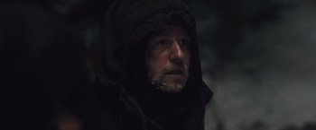 Movie still from “The Grey” (2011), directed by Joe Carnahan – A person wearing a hooded jacket; Close Up shot, Over the shoulder angle