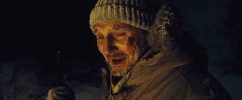 Movie still from “The Grey” (2011), directed by Joe Carnahan – An old man with a beard and a hat; Close Up shot, Over the shoulder angle