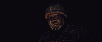 Movie still from “The Grey” (2011), directed by Joe Carnahan – A person wearing a hat; Close Up shot, Low angle
