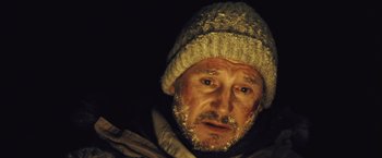 Movie still from “The Grey” (2011), directed by Joe Carnahan – A person wearing a hat; Close Up shot, High angle
