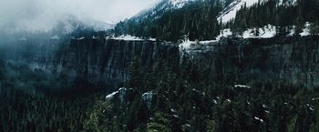 Movie still from “The Grey” (2011), directed by Joe Carnahan – A view of a mountain with trees in the background; Extreme Wide shot, High angle