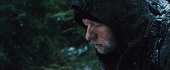 Movie still from “The Grey” (2011), directed by Joe Carnahan – A person wearing a black jacket; Close Up shot, Over the shoulder angle