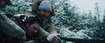 Movie still from “The Grey” (2011), directed by Joe Carnahan – A man and a woman in the snow; Medium shot, Over the shoulder angle