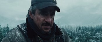 Movie still from “The Grey” (2011), directed by Joe Carnahan – A person wearing a hat; Close Up shot, Low angle