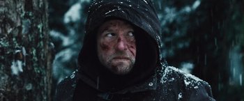 Movie still from “The Grey” (2011), directed by Joe Carnahan – A person wearing a hooded jacket; Close Up shot, Over the shoulder angle
