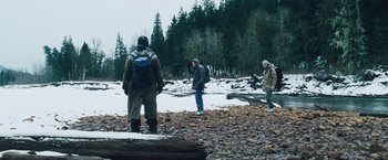 Movie still from “The Grey” (2011), directed by Joe Carnahan – A group of people standing on top of a rocky ground; Wide shot, Low angle