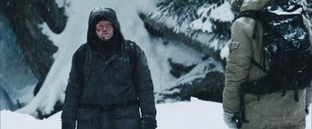 Movie still from “The Grey” (2011), directed by Joe Carnahan – A man standing in the middle of a snow covered field; Medium shot, Low angle