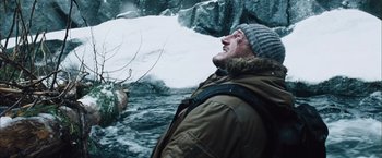 Movie still from “The Grey” (2011), directed by Joe Carnahan – An old man in a winter coat and a hat looking up at the sky; Close Up shot, Low angle