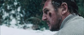 Movie still from “The Grey” (2011), directed by Joe Carnahan – A person with a face covered in snow; Close Up shot, Over the shoulder angle