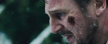 Movie still from “The Grey” (2011), directed by Joe Carnahan – A person with a bruise on his face; Extreme Close Up shot, Over the shoulder angle