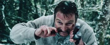 Movie still from “The Grey” (2011), directed by Joe Carnahan – A man is brushing his teeth outside in the snow; Close Up shot, High angle