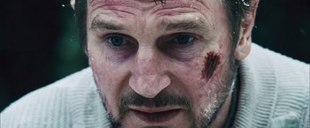 Movie still from “The Grey” (2011), directed by Joe Carnahan – A person with blood all over his face; Close Up shot, Over the shoulder angle