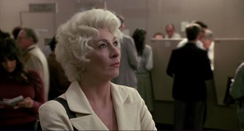 Movie still from “The Grifters” (1990), directed by Stephen Frears – An older woman with white hair looking up at something; Close Up shot, Over the shoulder angle