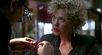Movie still from “The Grifters” (1990), directed by Stephen Frears – A person with a ring on their finger; Close Up shot, Over the shoulder angle