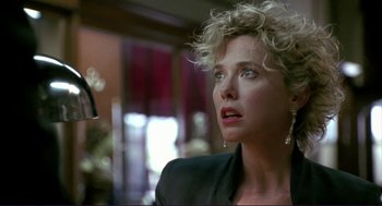 Movie still from “The Grifters” (1990), directed by Stephen Frears – A person wearing a suit and tie; Close Up shot, Low angle