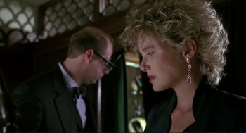 Movie still from “The Grifters” (1990), directed by Stephen Frears – A man and a woman standing next to each other; Close Up shot, Low angle