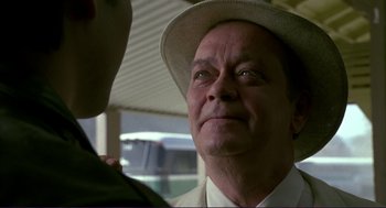 Movie still from “The Grifters” (1990), directed by Stephen Frears – An older man wearing a white hat looking at a younger man; Close Up shot, Over the shoulder angle