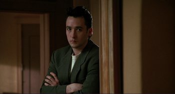 Movie still from “The Grifters” (1990), directed by Stephen Frears – A man in a green jacket standing in front of a mirror; Close Up shot, Low angle