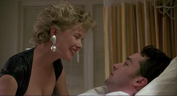 Movie still from “The Grifters” (1990), directed by Stephen Frears – A man and a woman smiling at each other; Close Up shot, Low angle