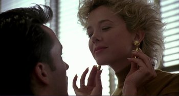 Movie still from “The Grifters” (1990), directed by Stephen Frears – A man and a woman looking into each others eyes; Close Up shot, Low angle