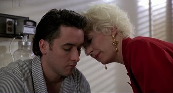 Movie still from “The Grifters” (1990), directed by Stephen Frears – An older woman touching the forehead of a younger man; Close Up shot, Low angle