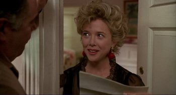 Movie still from “The Grifters” (1990), directed by Stephen Frears – A person wearing a black shirt; Close Up shot, Over the shoulder angle