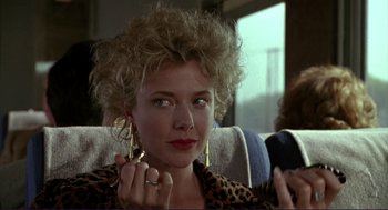 Movie still from “The Grifters” (1990), directed by Stephen Frears – A person wearing a leopard print jacket; Close Up shot, Over the shoulder angle