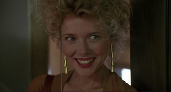 Movie still from “The Grifters” (1990), directed by Stephen Frears – A person with a smile on their face; Close Up shot, Low angle