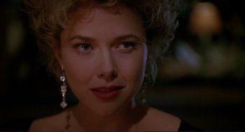 Movie still from “The Grifters” (1990), directed by Stephen Frears – A woman's face in a dark room; Close Up shot, Over the shoulder angle