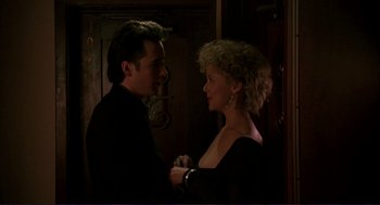 Movie still from “The Grifters” (1990), directed by Stephen Frears – A man and a woman are dancing in a dark room; Medium shot, Low angle