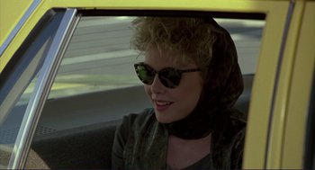 Movie still from “The Grifters” (1990), directed by Stephen Frears – A woman sitting in the back seat of a car; Close Up shot, Over the shoulder angle