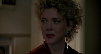 Movie still from “The Grifters” (1990), directed by Stephen Frears – A person wearing a red shirt; Close Up shot, Over the shoulder angle