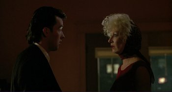 Movie still from “The Grifters” (1990), directed by Stephen Frears – A man and a woman talking to each other; Close Up shot, Over the shoulder angle
