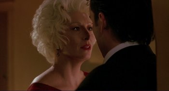 Movie still from “The Grifters” (1990), directed by Stephen Frears – An older woman and a younger man are looking at each other; Close Up shot, Over the shoulder angle