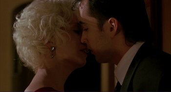 Movie still from “The Grifters” (1990), directed by Stephen Frears – A man and a woman are kissing in a room; Close Up shot, Low angle