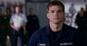 Movie still from “The Guardian” (2006), directed by Andrew Davis – A young man in a navy blue shirt and jacket; Close Up shot, Over the shoulder angle