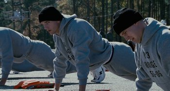Movie still from “The Guardian” (2006), directed by Andrew Davis – A group of young men doing push - ups on the street; Medium shot, Low angle