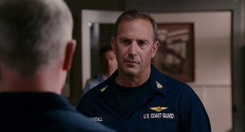 Movie still from “The Guardian” (2006), directed by Andrew Davis – A man in a navy uniform talking to another man in uniform; Close Up shot, Over the shoulder angle