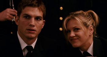 Movie still from “The Guardian” (2006), directed by Andrew Davis – A man and a woman posing for a picture; Close Up shot, Low angle