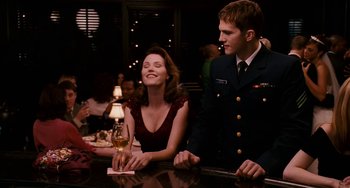 Movie still from “The Guardian” (2006), directed by Andrew Davis – A man and a woman sitting at a table with a glass of wine in front of them; Medium shot, Over the shoulder angle