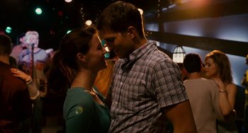 Movie still from “The Guardian” (2006), directed by Andrew Davis – A man and a woman standing next to each other; Medium shot, Over the shoulder angle