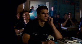 Movie still from “The Guardian” (2006), directed by Andrew Davis – A group of men sitting in a room talking on cellphones; Medium shot, Over the shoulder angle